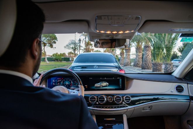 Luxury Mercedes interior with professional chauffeur, private transfer Malaga to Gibraltar border