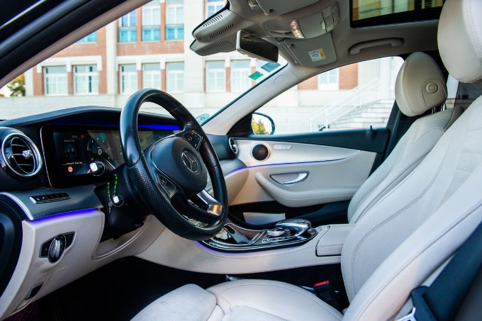 Interior espacioso y elegante de un vehículo de transfer de lujo, con asientos de cuero y acabados premium.