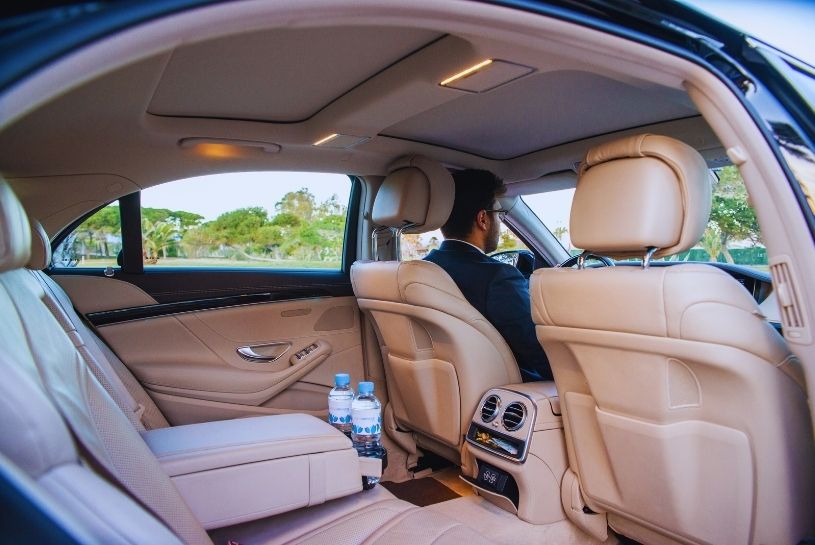 Interior of a luxury vehicle featuring light brown leather seats and elegant finishes.